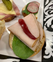 Image of an open faced finger sandwich at funeral luncheon reception